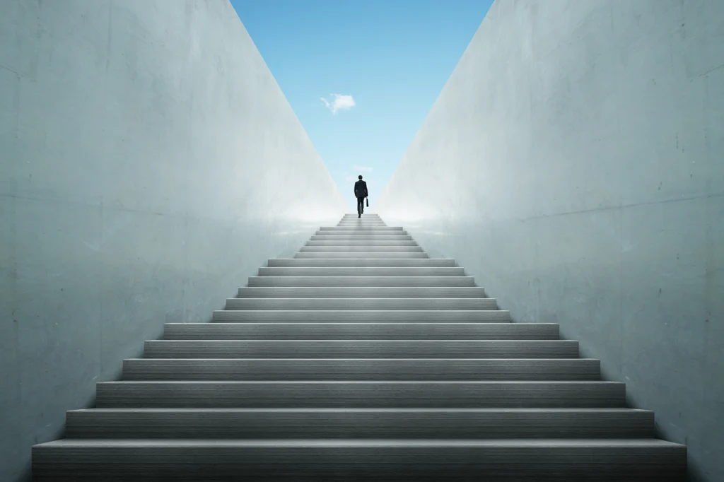 Businessman climbing stairs ,Ambitions concept, scaling growth